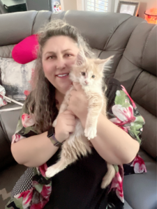 Maine Coon Kittens ⋆ Sassy Koonz Maine Coon Cattery lady holding cream and white maine coon kitten