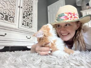 Lady Wearing Hat With Maine Coon Kitten ⋆ Sassy Koonz Maine Coon Cattery new owner admiring her new maine coon kitten